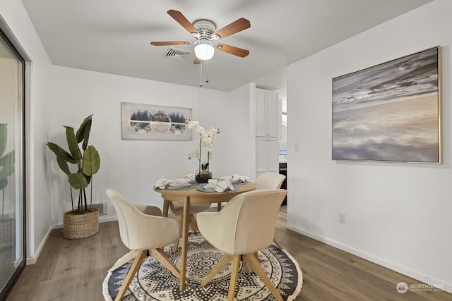 dining area with ceiling fan and hardwood / wood-style floors