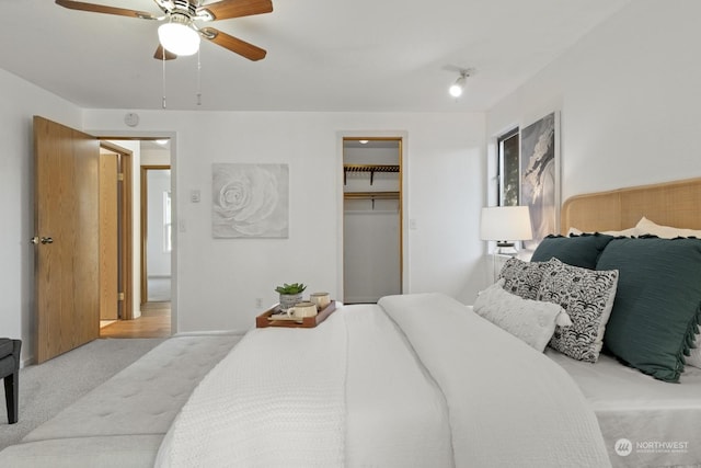 carpeted bedroom with ceiling fan and a closet