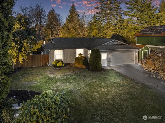 view of front of house featuring a garage and a lawn