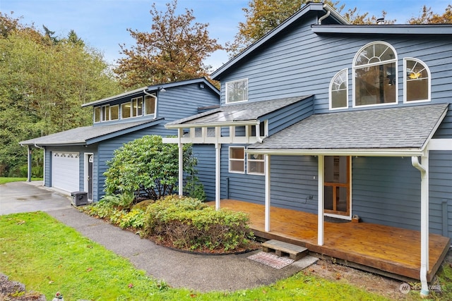 view of home's exterior with a deck and a garage