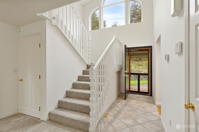 entrance foyer with a high ceiling and light tile patterned floors