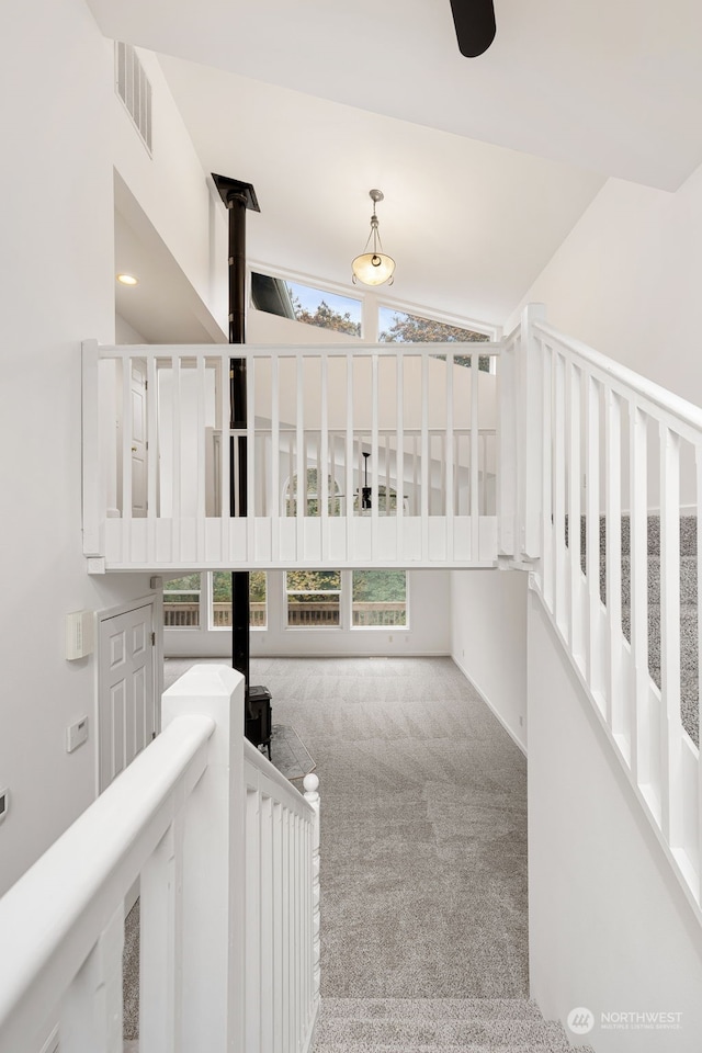 interior space featuring light carpet and vaulted ceiling