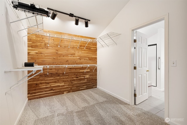 spacious closet featuring light colored carpet and vaulted ceiling