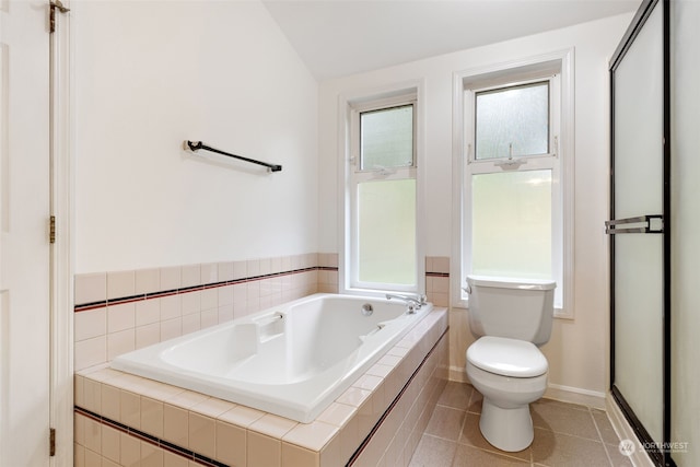 bathroom featuring toilet, lofted ceiling, tile patterned floors, and separate shower and tub