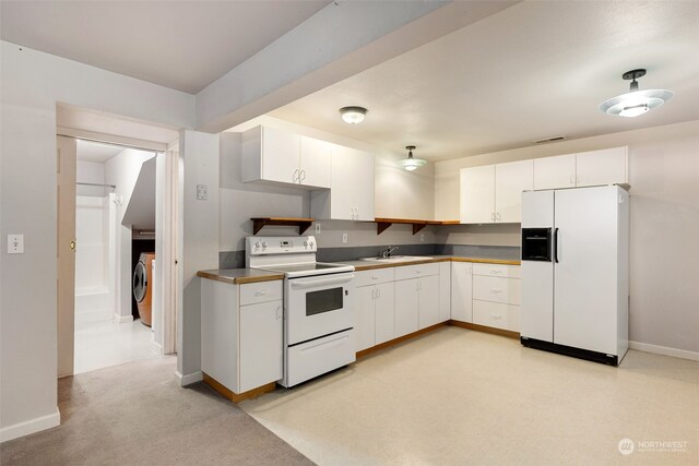 kitchen featuring sink, white cabinets, white appliances, and washer / clothes dryer