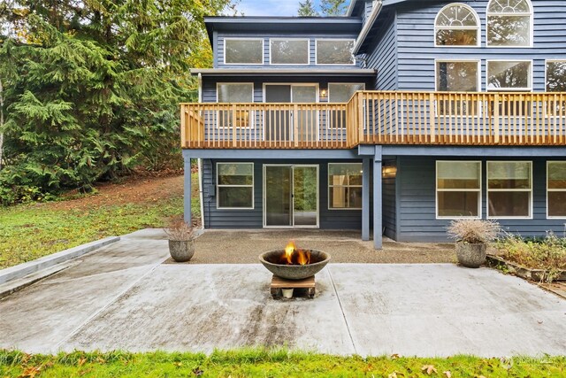 back of house with a patio and a fire pit