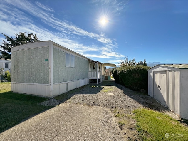 view of home's exterior featuring a storage shed