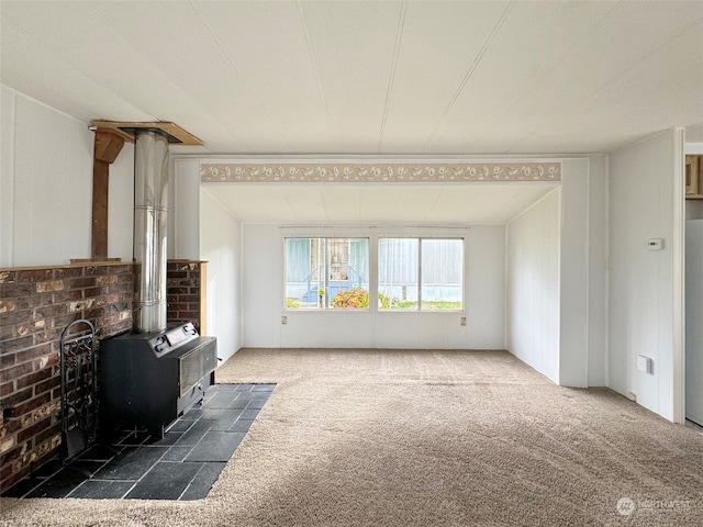 living room featuring a wood stove and dark colored carpet