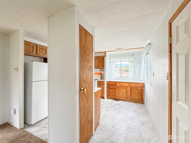 kitchen featuring wood walls and white appliances