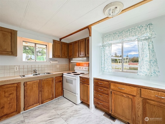 kitchen with white electric range, a textured ceiling, sink, and backsplash