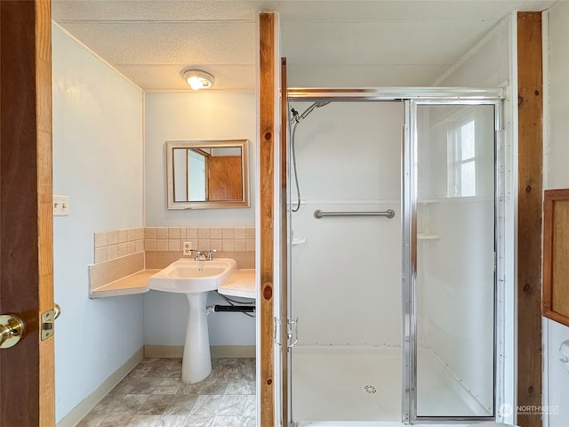 bathroom with a shower with door