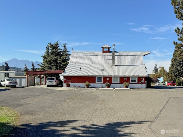 view of front facade featuring a mountain view and a carport