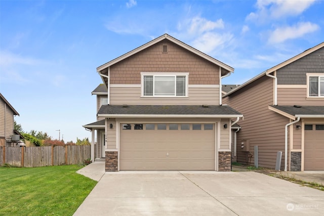 craftsman inspired home featuring a front lawn and a garage