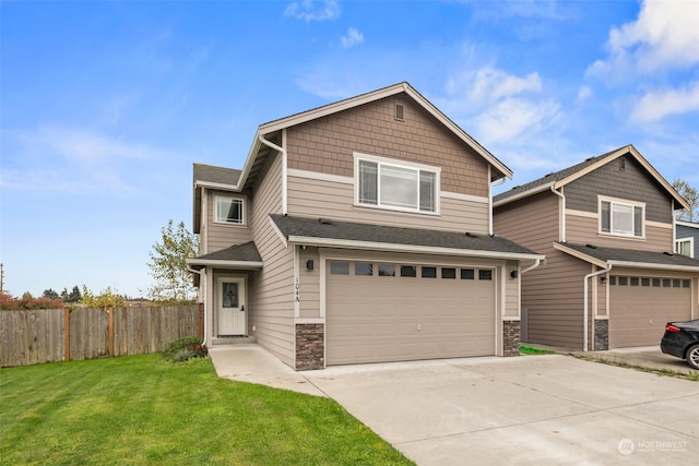 view of front of house featuring a front yard and a garage