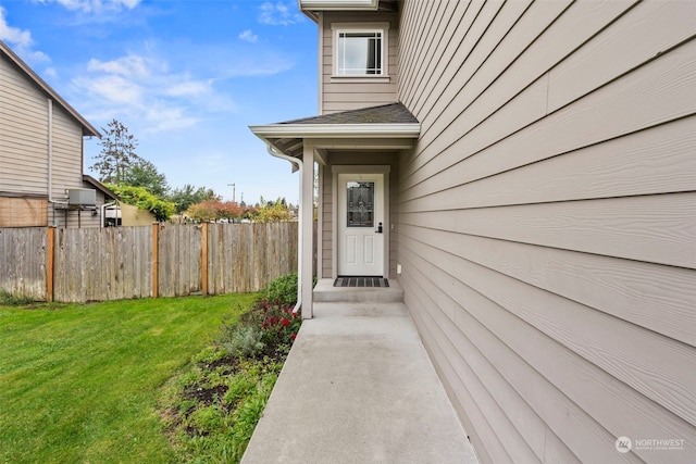 entrance to property with a lawn