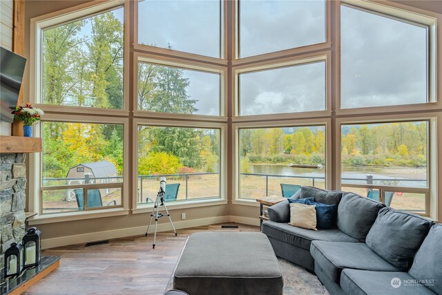 sunroom / solarium with a water view and a wealth of natural light