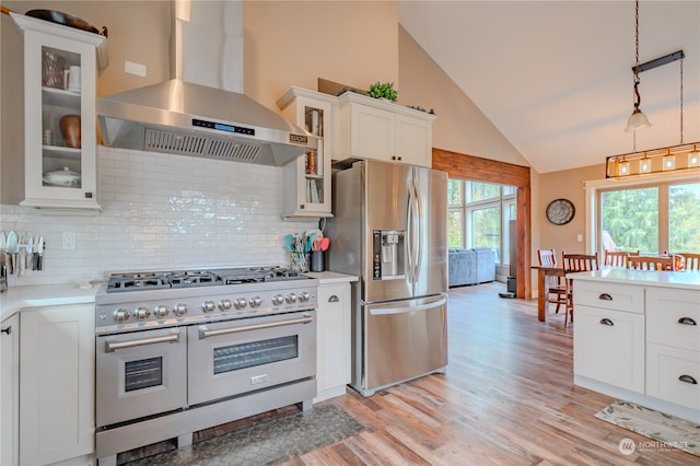 kitchen featuring white cabinetry, stainless steel appliances, wall chimney exhaust hood, and light wood-type flooring