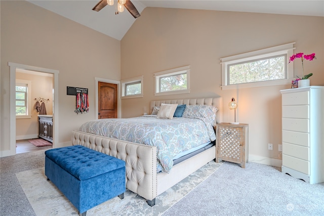 bedroom featuring ceiling fan, high vaulted ceiling, carpet, and multiple windows