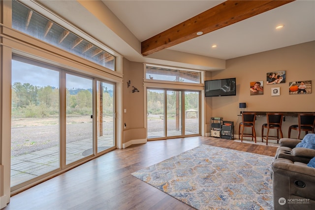 living room with beam ceiling and hardwood / wood-style flooring