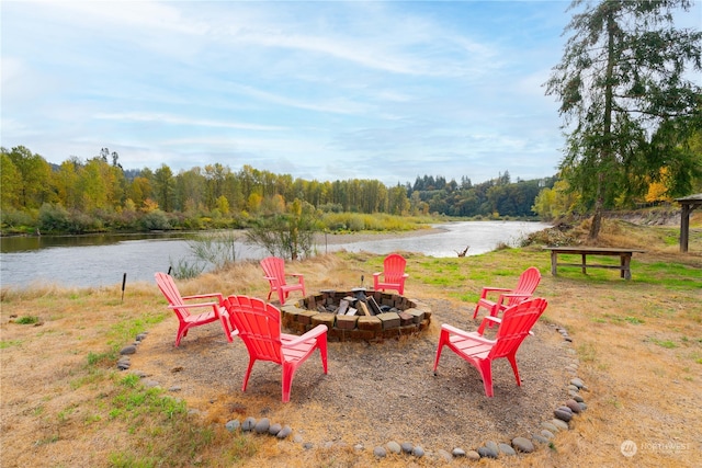 view of yard featuring an outdoor fire pit and a water view