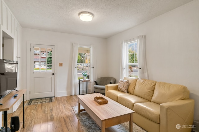 living area featuring a textured ceiling and light wood-type flooring