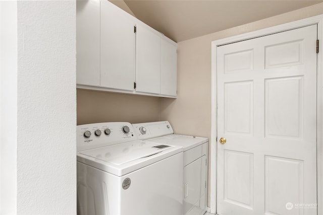 laundry area with washing machine and dryer and cabinet space