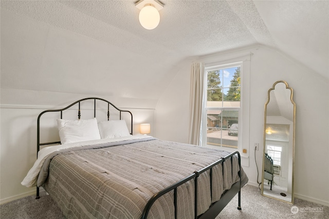 carpeted bedroom with a textured ceiling, lofted ceiling, and baseboards