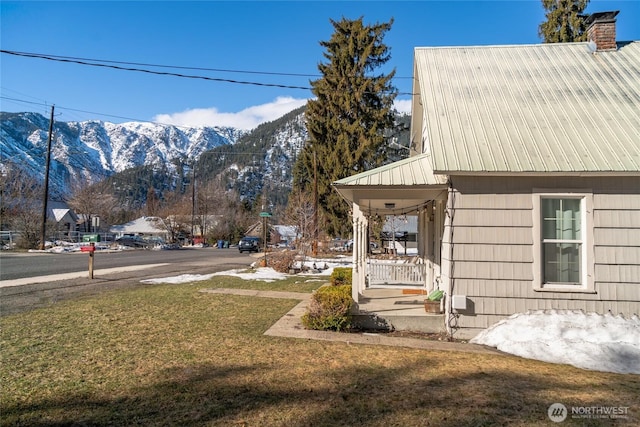 view of yard featuring a mountain view and a porch