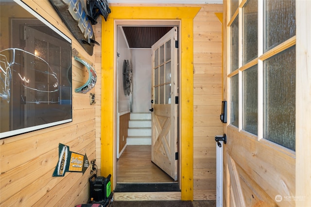 hall featuring wood walls and hardwood / wood-style floors