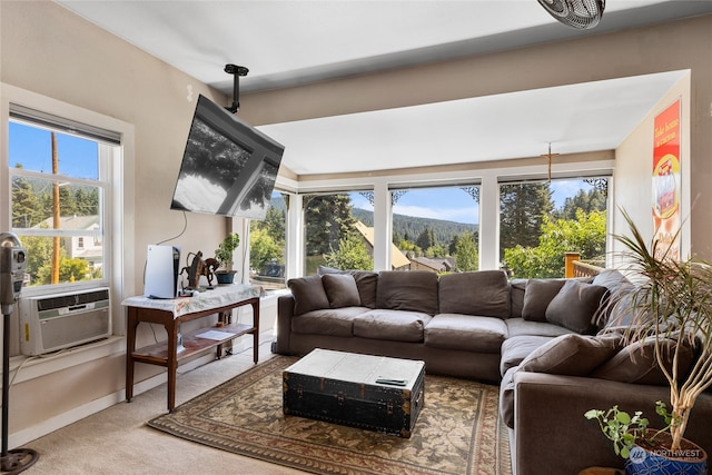 living room with cooling unit, carpet flooring, and plenty of natural light