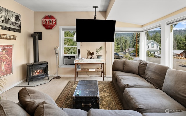 living room with a wood stove, carpet floors, lofted ceiling, and cooling unit