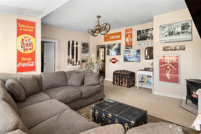 living room with carpet and a wood stove