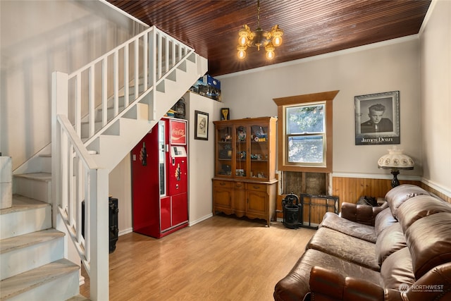 living room with crown molding, wooden ceiling, light hardwood / wood-style flooring, and a chandelier