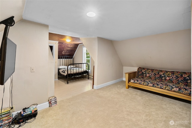 carpeted bedroom with lofted ceiling