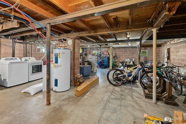 basement featuring water heater and washing machine and clothes dryer