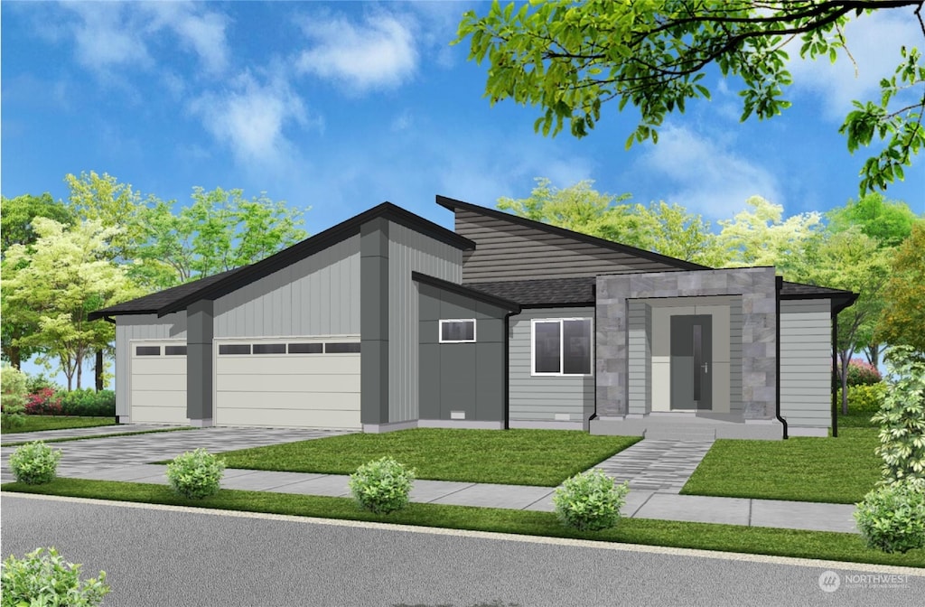 view of front of house with a front yard and a garage