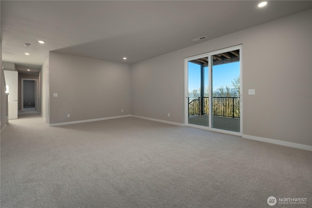 unfurnished room featuring recessed lighting, light colored carpet, and baseboards