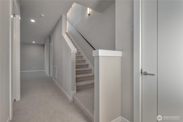 stairway with visible vents, baseboards, carpet flooring, and recessed lighting