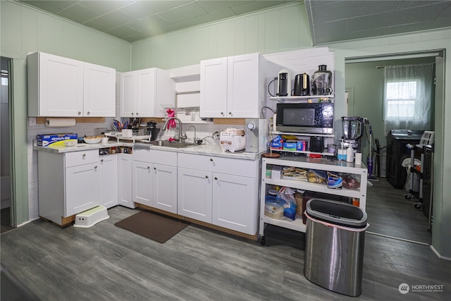 kitchen featuring white cabinetry, dark hardwood / wood-style flooring, and sink