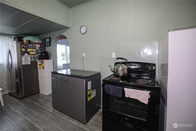 kitchen with black electric range oven, stainless steel fridge, wood-type flooring, and white refrigerator