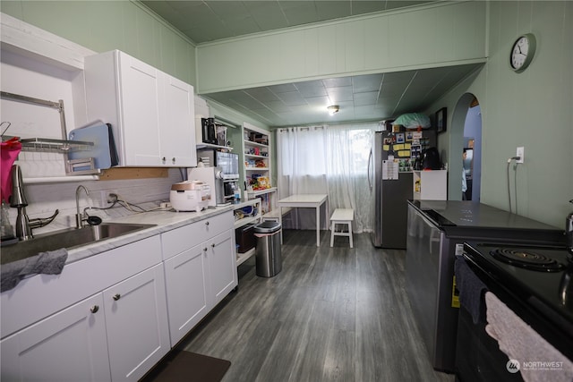 kitchen with sink, dark wood-type flooring, stainless steel fridge, white cabinets, and black range with electric cooktop