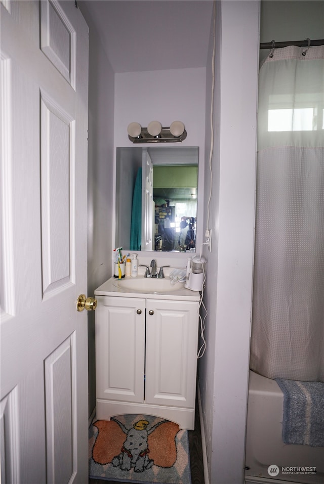 bathroom with shower / tub combo with curtain and vanity