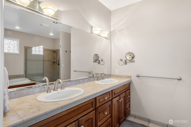 bathroom with vanity, tile patterned floors, and plus walk in shower