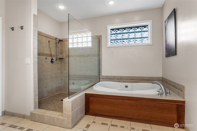 bathroom featuring independent shower and bath and tile patterned flooring