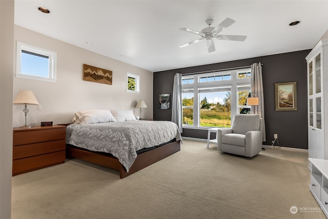 bedroom featuring light carpet and ceiling fan