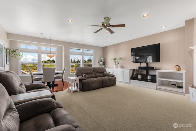 carpeted living room featuring ceiling fan and plenty of natural light