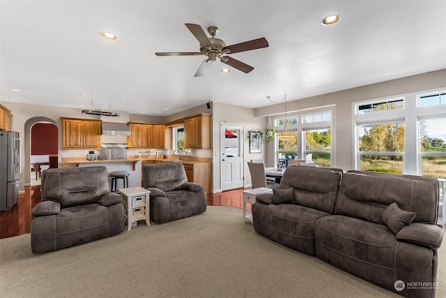 living room with light hardwood / wood-style floors and ceiling fan