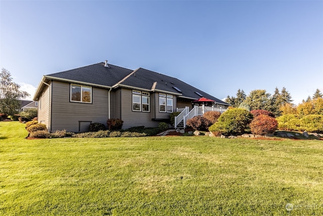 rear view of house with a yard