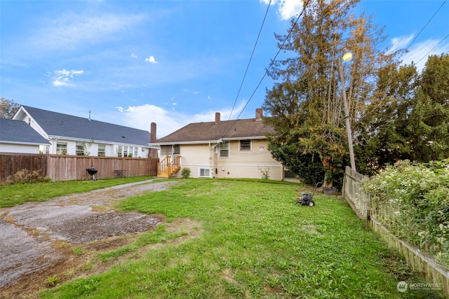 rear view of house with a lawn