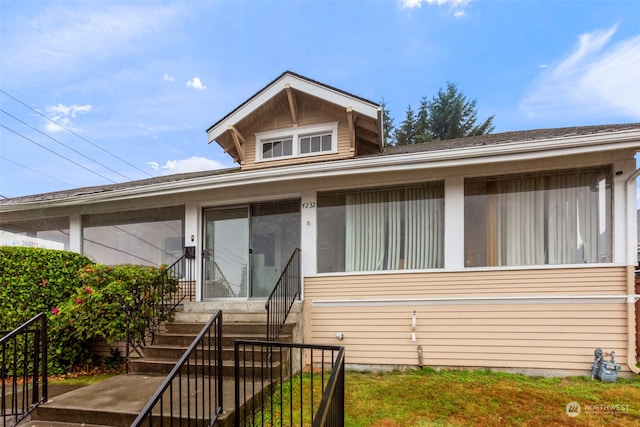 view of front of property with a sunroom